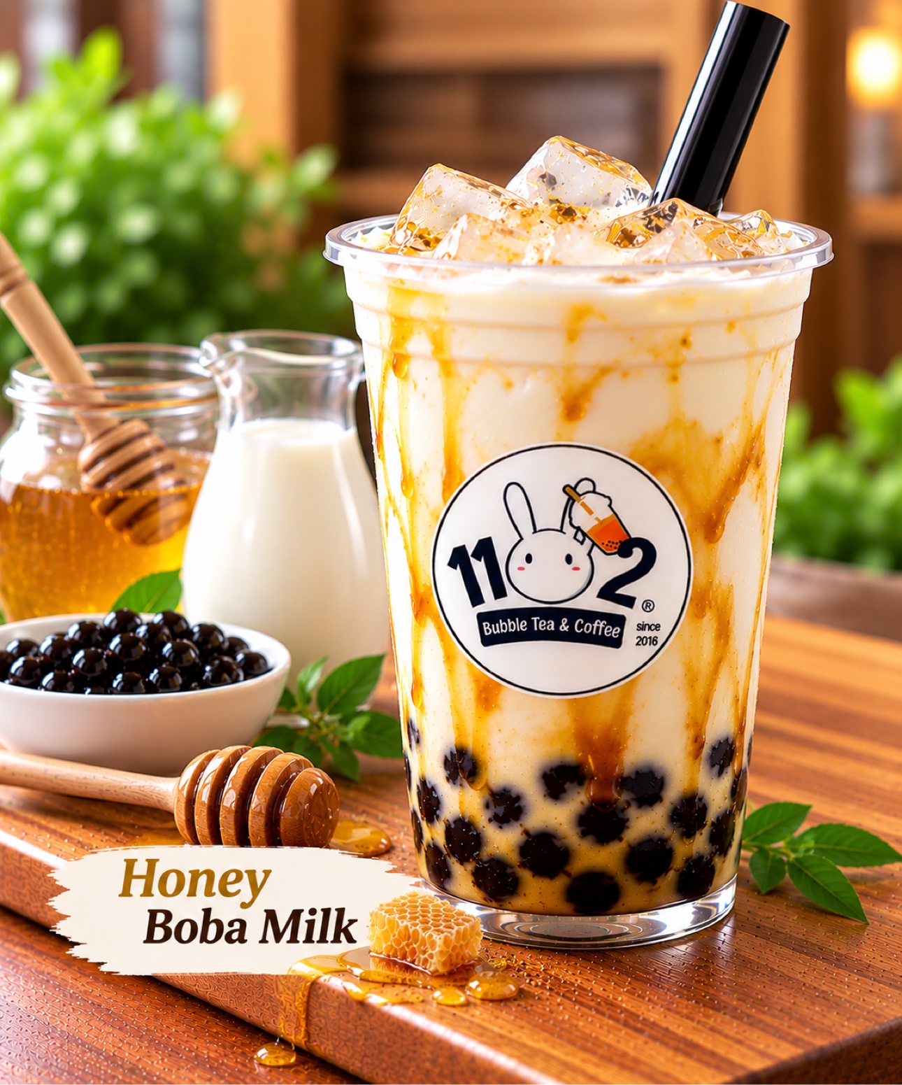 Honey boba milk in a cup with the 1102 shop logo sticker