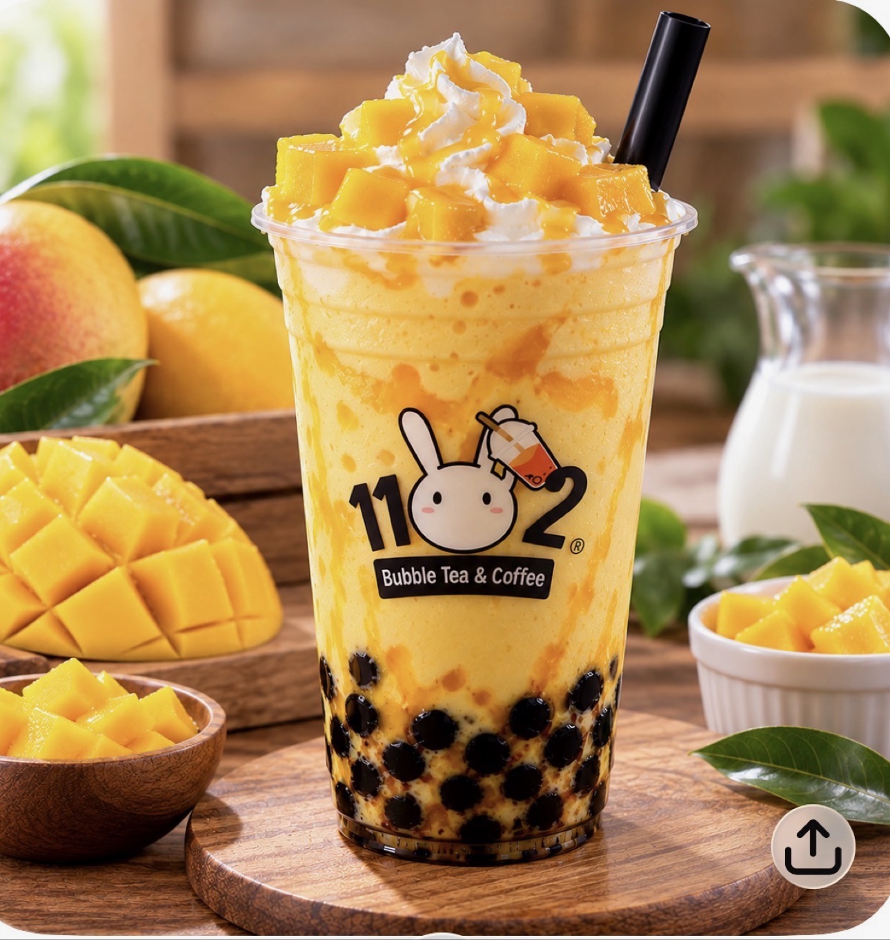 Mango smoothie with boba in a cup with the 1102 shop logo