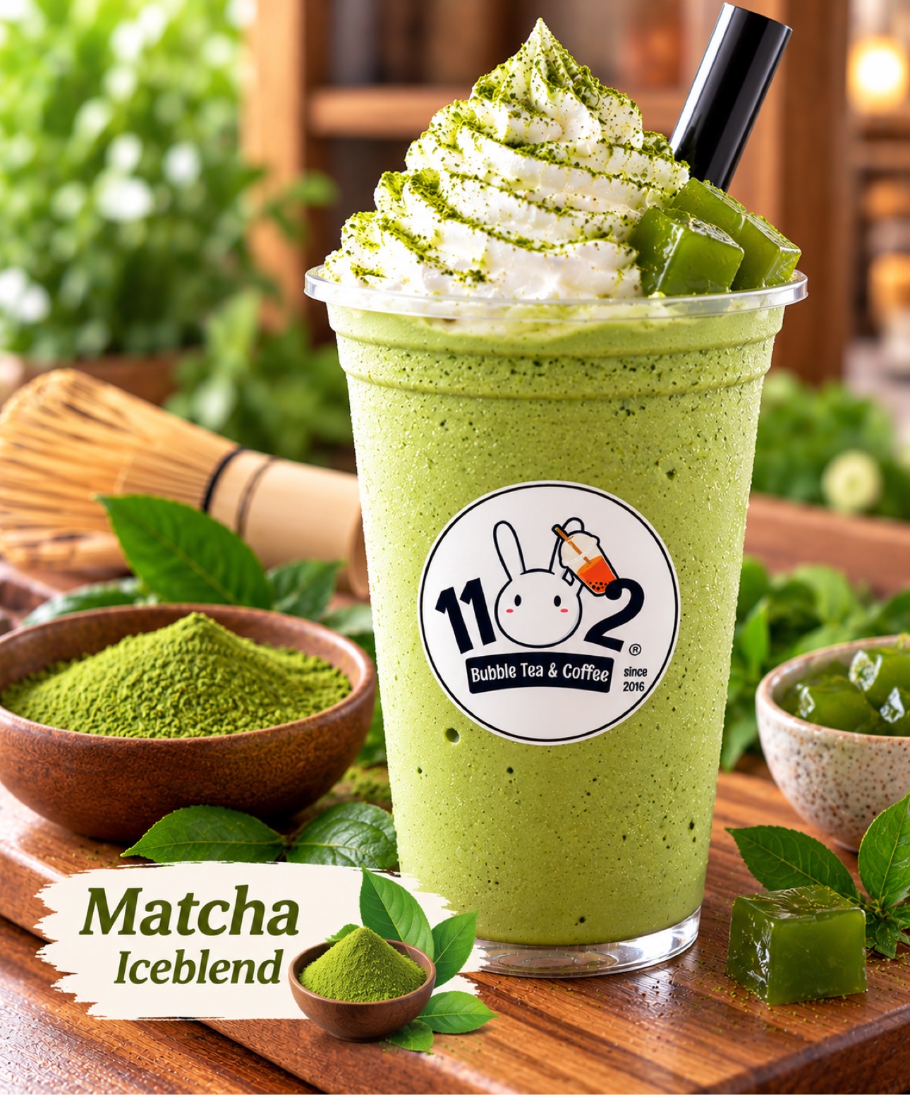 Matcha iceblend with whipped cream in a cup with the 1102 shop logo sticker