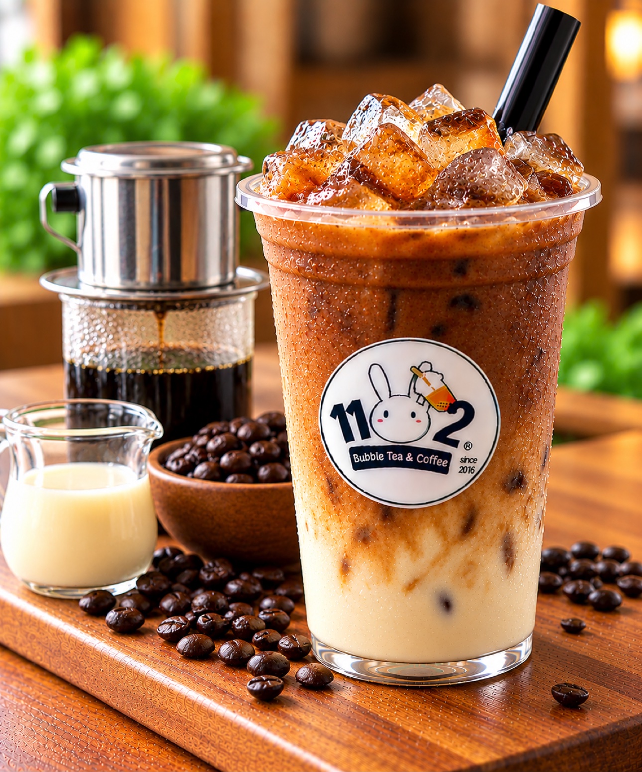 Vietnamese milk coffee in a cup with the 1102 shop logo sticker